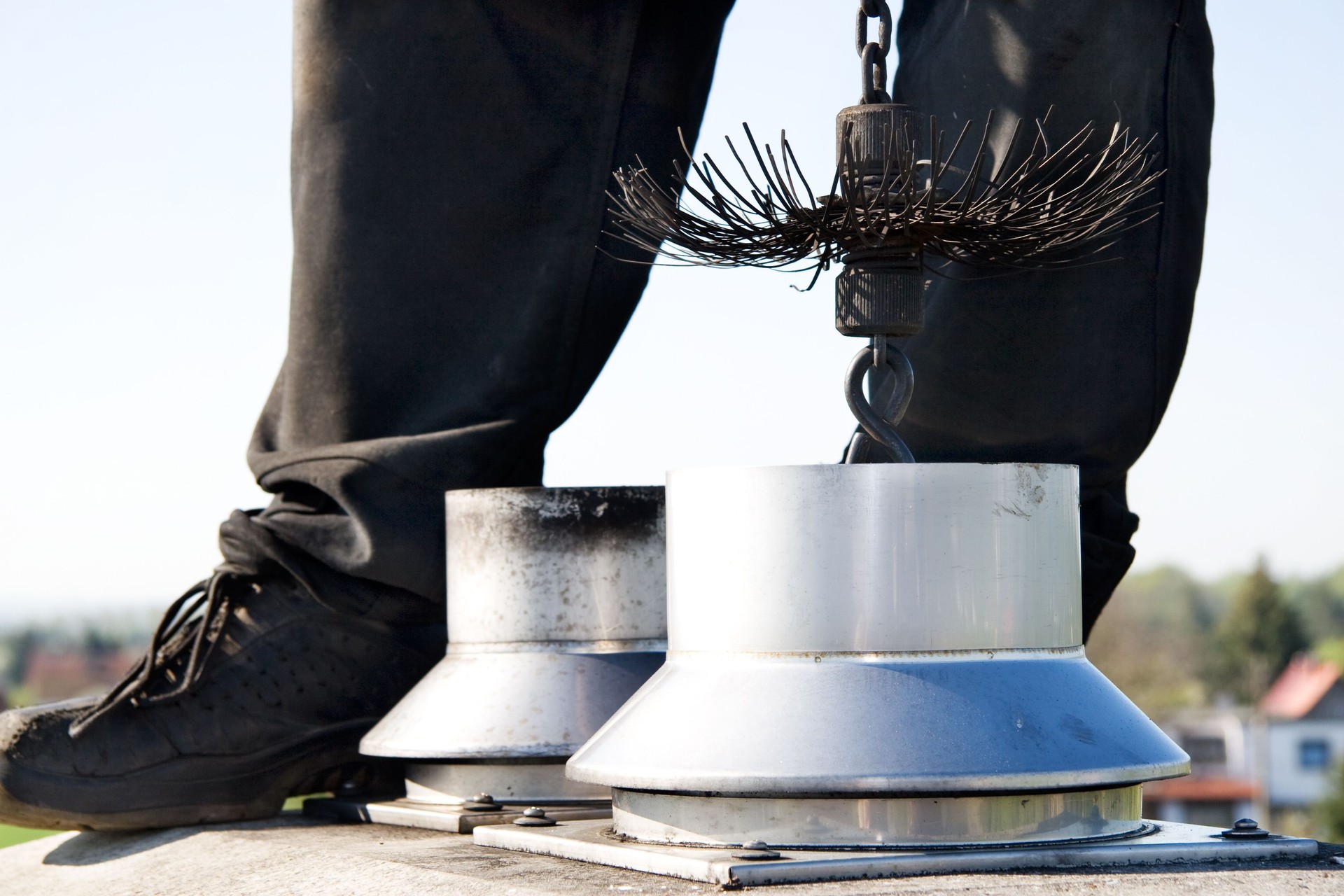 close up of a chimney sweep on the roof